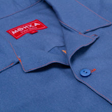 Load image into Gallery viewer, Close-up of a blue shirt with a red label on the collar.
