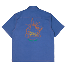 Load image into Gallery viewer, the back of the tulip shirt portraying the big vase of depressed tulips on an orange embroidery against that blue steel soft cotton. MOHXA is embroidered in yellow and the title &quot;depressed tulips&quot; in green.
